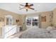 Bright bedroom with a large window, ceiling fan, white dresser, and a small desk at 9877 Wading Crane Ave, Fishers, IN 46055