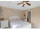 Bedroom with a ceiling fan, bedside table, and decorative wall art at 9877 Wading Crane Ave, Fishers, IN 46055