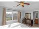 Sunlit bedroom featuring a ceiling fan, modern dresser, and ensuite access at 9877 Wading Crane Ave, Fishers, IN 46055