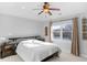 Bedroom with a modern dresser, bedside table, and large sunlit window at 9877 Wading Crane Ave, Fishers, IN 46055