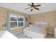 Bright bedroom with a large window, ceiling fan, and white furniture at 9877 Wading Crane Ave, Fishers, IN 46055