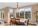 Inviting dining area with large windows and sliding glass doors, offering scenic views and natural light at 9877 Wading Crane Ave, Fishers, IN 46055