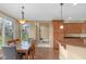 Bright dining area open to kitchen, featuring a view of the fireplace and backyard at 9877 Wading Crane Ave, Fishers, IN 46055