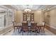 Dining room with coffered ceiling, chandelier and a display cabinet for storage at 9877 Wading Crane Ave, Fishers, IN 46055