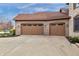 A three-car garage showcasing matching doors at 9877 Wading Crane Ave, Fishers, IN 46055