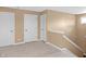 Upstairs hallway featuring carpeted floor, doors, and staircase at 9877 Wading Crane Ave, Fishers, IN 46055