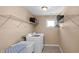 Laundry room equipped with a washing machine, dryer, and storage shelves at 9877 Wading Crane Ave, Fishers, IN 46055