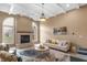 Bright living room featuring a fireplace, arched windows, and decorative ceiling at 9877 Wading Crane Ave, Fishers, IN 46055