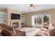 Comfortable living room with a fireplace, built-in bookshelves, and sliding glass doors leading to the deck at 9877 Wading Crane Ave, Fishers, IN 46055