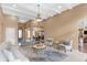 Bright living room featuring a fireplace, arched windows, decorative ceiling, and access to dining room at 9877 Wading Crane Ave, Fishers, IN 46055