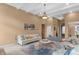 Bright living room featuring a fireplace, arched windows, and decorative ceiling, and access to dining room at 9877 Wading Crane Ave, Fishers, IN 46055