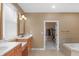 Large bathroom features a walk-in closet, a large tub, and a double vanity with mirrors at 9877 Wading Crane Ave, Fishers, IN 46055