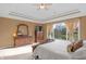 Bright main bedroom with a large window view, traditional style dressers, and a ceiling fan at 9877 Wading Crane Ave, Fishers, IN 46055