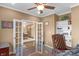 Office space featuring a large desk with double french doors to the dining room at 9877 Wading Crane Ave, Fishers, IN 46055