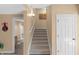 Carpeted staircase with white railings and a light fixture, leading to the upper level at 9877 Wading Crane Ave, Fishers, IN 46055