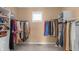 Spacious walk-in closet with custom shelving and natural light, ideal for organizing your wardrobe at 9877 Wading Crane Ave, Fishers, IN 46055