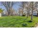 Lush backyard with a spacious lawn and mature trees, providing a serene and private outdoor space at 102 E Thompson St, Lebanon, IN 46052