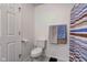 Bathroom interior featuring a toilet, a horizontally striped shower curtain, and towel hooks at 102 E Thompson St, Lebanon, IN 46052
