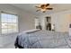 This bedroom has neutral carpet, a ceiling fan, walk-in closet, and large windows at 102 E Thompson St, Lebanon, IN 46052