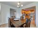 Dining room with wooden table and chairs, seamlessly connecting to the adjacent kitchen at 102 E Thompson St, Lebanon, IN 46052