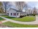 Single-story home with a metal roof, manicured lawn, and a detached garage at 102 E Thompson St, Lebanon, IN 46052