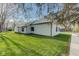 Charming home featuring white siding, a metal roof, and a well-manicured lawn, with nearby trees at 102 E Thompson St, Lebanon, IN 46052