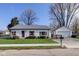 Charming single-story home with well-maintained lawn, metal roof, and a detached garage at 102 E Thompson St, Lebanon, IN 46052