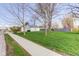 A house with a well-maintained lawn, sidewalk, and street, and plenty of shade trees at 102 E Thompson St, Lebanon, IN 46052
