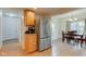 Bright kitchen with oak cabinets, stainless steel refrigerator, and dining room access at 102 E Thompson St, Lebanon, IN 46052