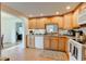 Kitchen with a view of dining room, oak cabinets, white appliances, and cozy atmosphere at 102 E Thompson St, Lebanon, IN 46052