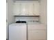 This laundry room features a white Whirlpool washer and dryer at 102 E Thompson St, Lebanon, IN 46052