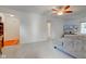Cozy living area showcasing neutral carpet, a ceiling fan, and a view of adjoining rooms at 102 E Thompson St, Lebanon, IN 46052