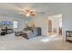 Bright living room featuring neutral carpet, a ceiling fan, and a large sectional sofa at 102 E Thompson St, Lebanon, IN 46052