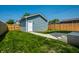 New backyard garage with light blue siding, concrete walkway, and newly seeded grass in a fenced yard at 1026 St Peter St, Indianapolis, IN 46203