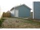 A detached garage in the backyard features light blue siding and a white door at 1026 St Peter St, Indianapolis, IN 46203