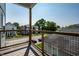 View from a balcony showcasing the neighborhood with modern homes, green trees, and a clear sky at 1026 St Peter St, Indianapolis, IN 46203