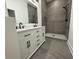 Bathroom with double sink vanity, large mirror, and tiled walk-in shower with rainfall showerhead at 1026 St Peter St, Indianapolis, IN 46203