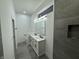 Bright bathroom featuring a double sink vanity, modern fixtures, and a spacious walk-in shower with elegant tile at 1026 St Peter St, Indianapolis, IN 46203