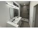 Bathroom featuring a double sink vanity, large mirror, and spacious walk-in shower with elegant tile at 1026 St Peter St, Indianapolis, IN 46203