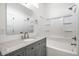 Bathroom featuring a vanity with a granite countertop, framed mirror, and a bathtub shower combination at 1026 St Peter St, Indianapolis, IN 46203