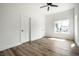 Bright bedroom with wood-look floors, white walls, a ceiling fan, and large windows, creating a peaceful retreat at 1026 St Peter St, Indianapolis, IN 46203