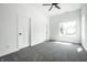 Bright, airy bedroom with gray carpet, white walls, and natural light from a large window at 1026 St Peter St, Indianapolis, IN 46203