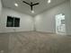 Spacious bedroom with neutral carpet, ceiling fan, ensuite bathroom, and walk-in closet at 1026 St Peter St, Indianapolis, IN 46203