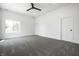 Spacious bedroom with gray carpet, a modern ceiling fan, and natural light from a large window at 1026 St Peter St, Indianapolis, IN 46203