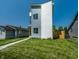 Side view of a modern two-story home showcasing its well-manicured lawn and modern architectural design at 1026 St Peter St, Indianapolis, IN 46203