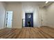 Hallway with vinyl floors provides access to several rooms; notice the blue accent wall at the top of the stairs at 1026 St Peter St, Indianapolis, IN 46203