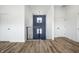 Bright hallway with hardwood floors, white walls, and a staircase with a unique metal railing at 1026 St Peter St, Indianapolis, IN 46203