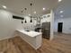 Modern kitchen features white cabinets, stainless steel appliances, and an island with a sink at 1026 St Peter St, Indianapolis, IN 46203