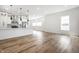 Spacious kitchen with white cabinets, stainless steel appliances, island seating, and wood-look floors in an open layout at 1026 St Peter St, Indianapolis, IN 46203