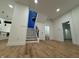 Open-concept living room with hardwood floors, staircase, and access to the kitchen and other rooms at 1026 St Peter St, Indianapolis, IN 46203